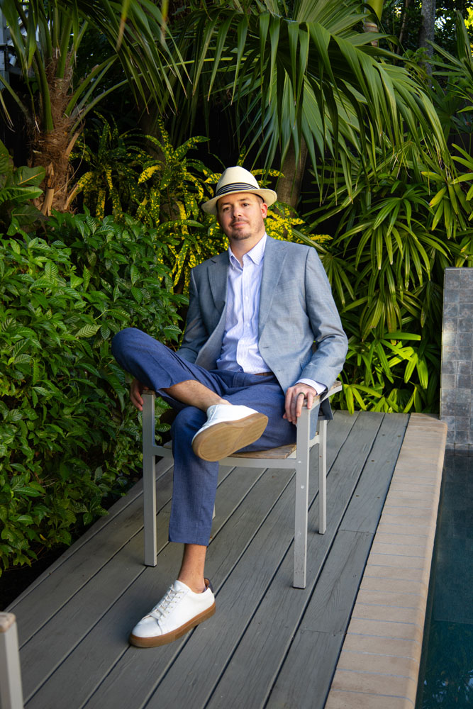 Greg from The Island Collective Realty standing in front of a Key West home, ready to help sellers list their property.