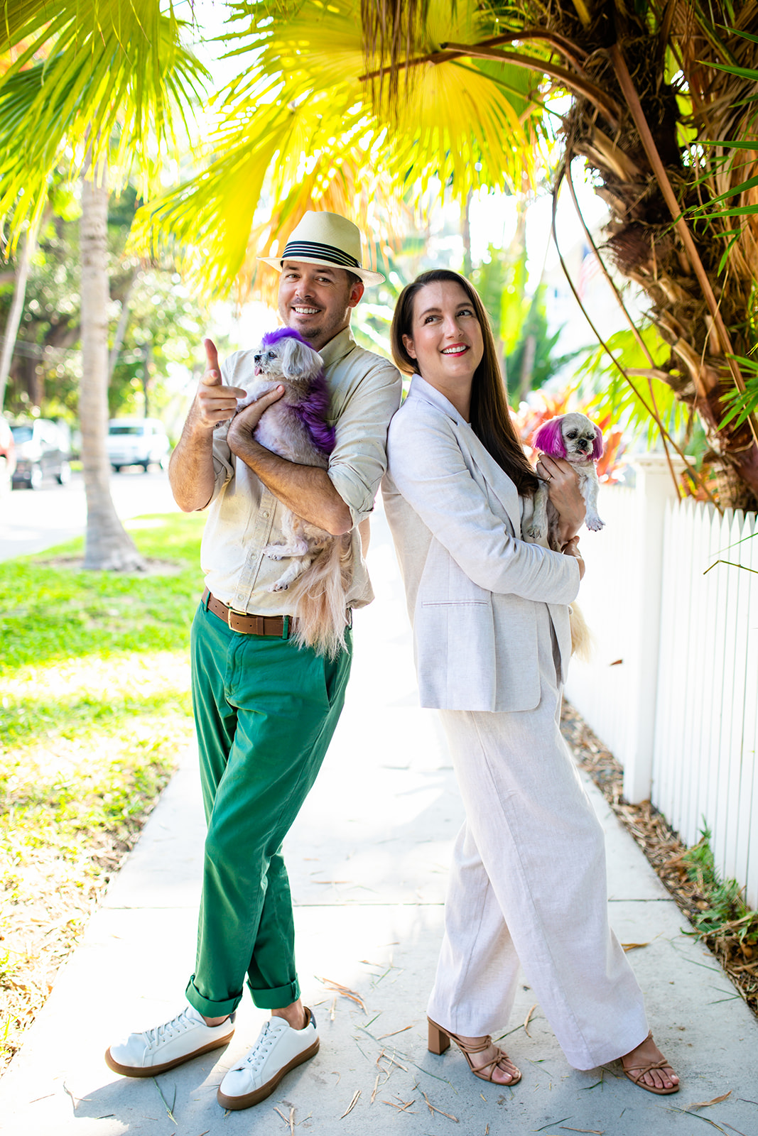 Greg and Stephanie, founders of The Island Collective Realty, holding Perry and Winnie in the Florida Keys to celebrate their new real estate brokerage launch.